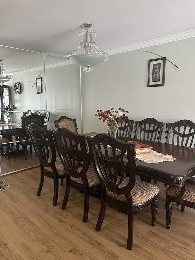 dining room featuring crown molding and wood finished floors