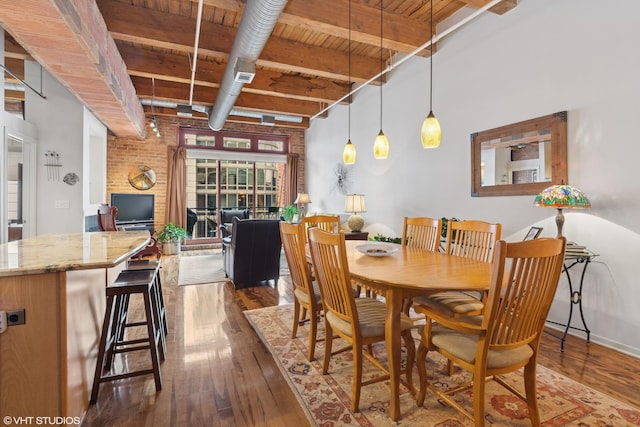 dining space featuring wood ceiling, wood-type flooring, visible vents, and beam ceiling