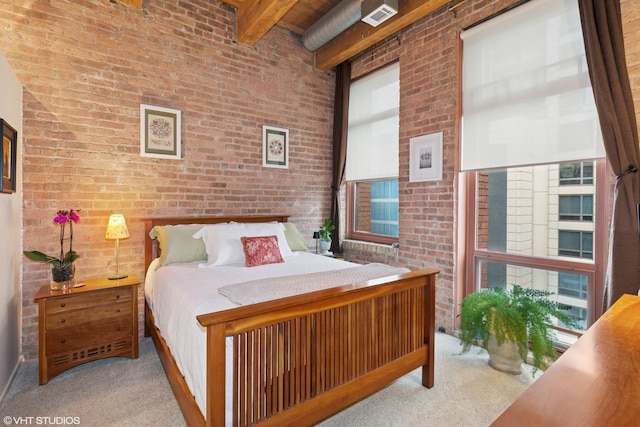 bedroom featuring brick wall, carpet, visible vents, and beamed ceiling