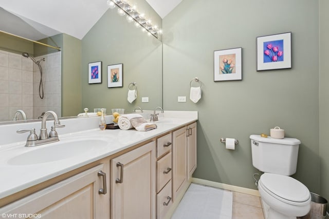 full bathroom featuring lofted ceiling, tile patterned flooring, toilet, and a sink