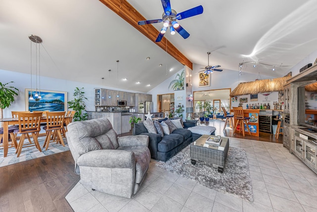 living room with light tile patterned floors, ceiling fan, high vaulted ceiling, and beamed ceiling