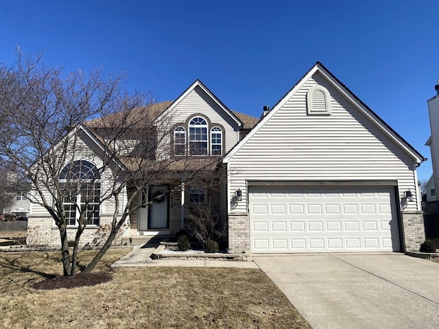 traditional home featuring an attached garage, brick siding, and driveway