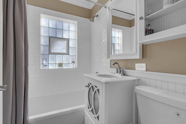 bathroom featuring plenty of natural light, toilet, vanity, and shower / bathtub combination with curtain