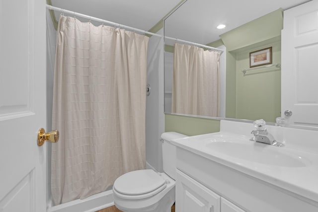 bathroom featuring vanity, toilet, and a shower with curtain