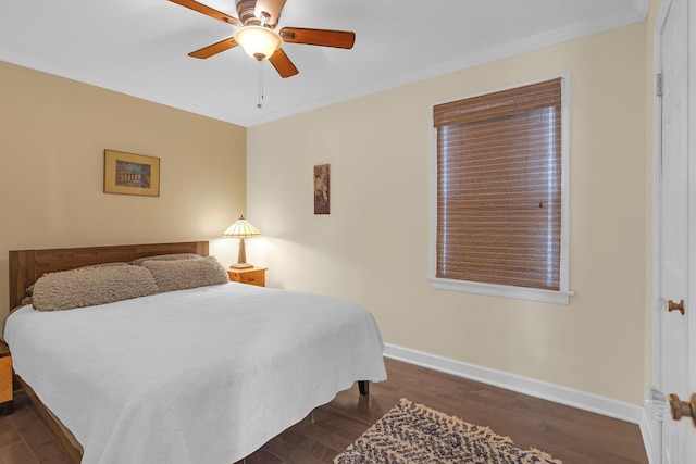 bedroom with dark wood-style floors, a ceiling fan, baseboards, and ornamental molding