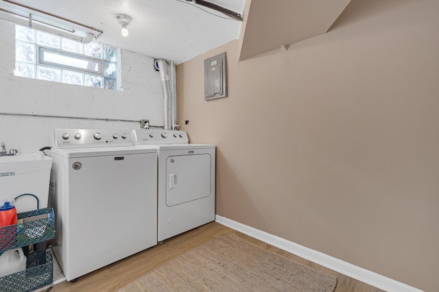 laundry room with laundry area, light wood-style flooring, washing machine and dryer, and baseboards