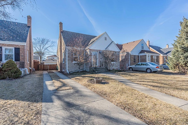 view of front of house with a front lawn and fence