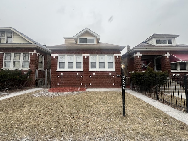 bungalow-style home with fence and brick siding