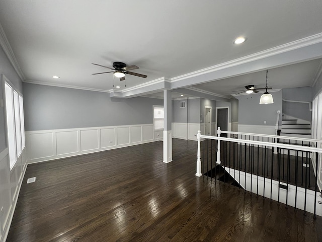 empty room featuring dark wood-style floors, recessed lighting, ornamental molding, and a ceiling fan