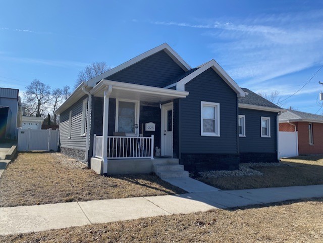 bungalow-style house with fence and a porch