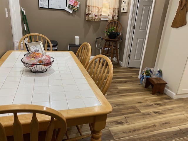 dining area featuring wood finished floors and baseboards