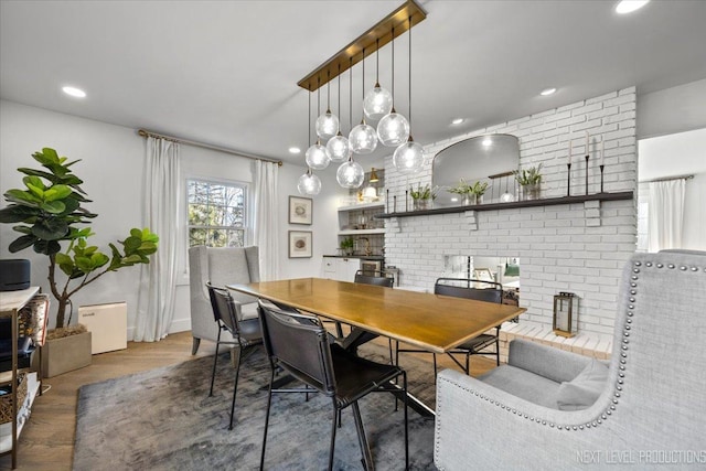 dining area with wood finished floors and recessed lighting