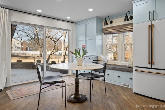 dining space with plenty of natural light, visible vents, dark wood-style flooring, and recessed lighting