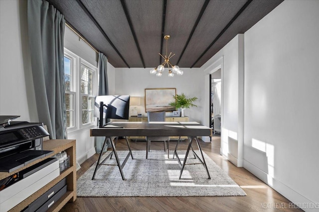 office with baseboards, wood finished floors, and a notable chandelier