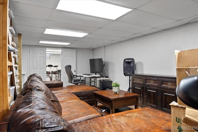 living room featuring a paneled ceiling