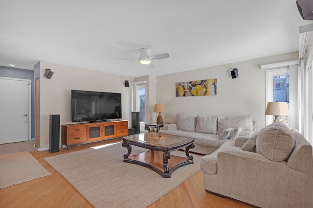 living area with light wood finished floors and ceiling fan