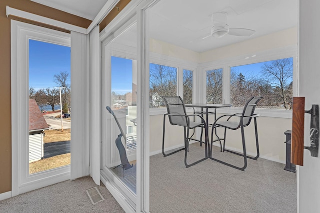 sunroom / solarium featuring visible vents and a ceiling fan