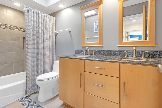 full bathroom with tile patterned flooring, double vanity, toilet, and a sink