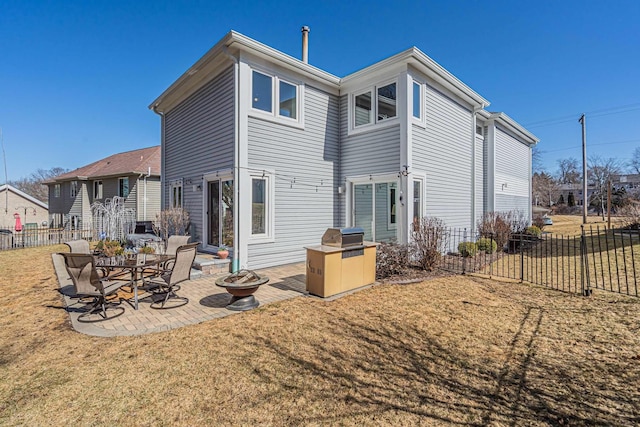 back of property featuring a patio area, fence, and a lawn