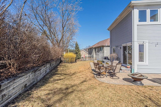 view of yard with a patio, a fire pit, and fence