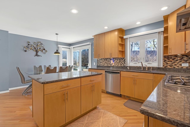 kitchen featuring a kitchen island, open shelves, a sink, stainless steel appliances, and light wood-style floors