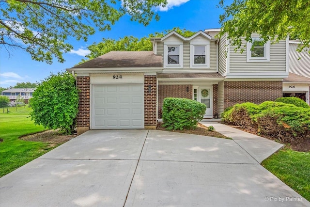 924 Colony Lake Dr, Schaumburg, IL 60194 - view of front of property featuring an attached garage, brick siding, concrete driveway, and roof with shingles