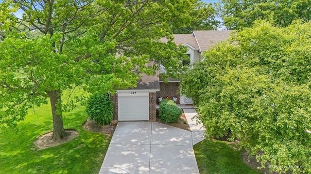 924 Colony Lake Dr, Schaumburg, IL 60194 - view of front of house with brick siding, roof with shingles, a front lawn, and driveway