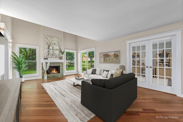 924 Colony Lake Dr, Schaumburg, IL 60194 - living area with french doors, a warm lit fireplace, wood finished floors, and vaulted ceiling