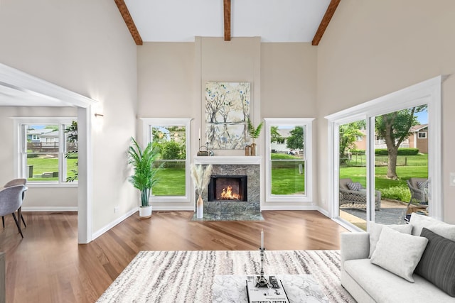 924 Colony Lake Dr, Schaumburg, IL 60194 - living area featuring a towering ceiling, wood finished floors, beam ceiling, and a fireplace with flush hearth