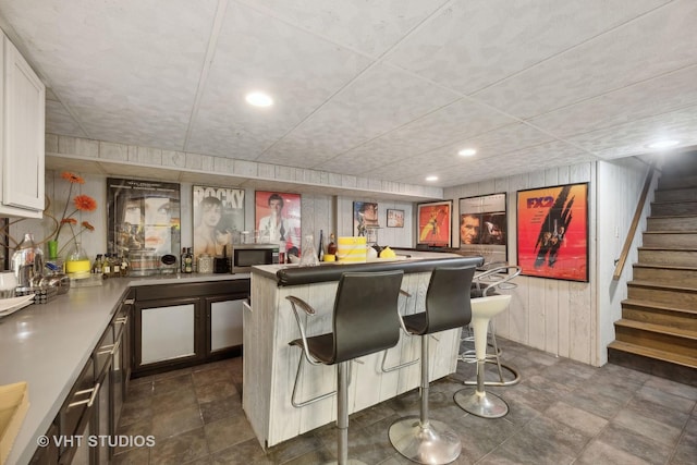 14930 W Wadsworth Rd, Wadsworth, IL 60083 - indoor wet bar featuring recessed lighting, stairway, wooden walls, and stainless steel microwave