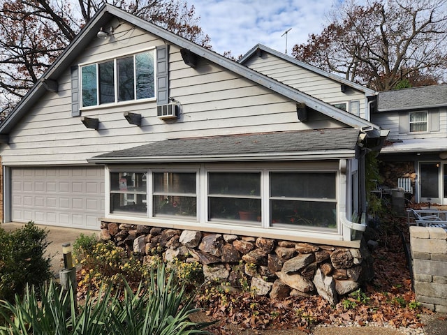 14930 W Wadsworth Rd, Wadsworth, IL 60083 - view of side of home featuring stone siding, driveway, an attached garage, cooling unit, and roof with shingles