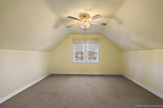 additional living space with lofted ceiling, carpet, baseboards, and ceiling fan