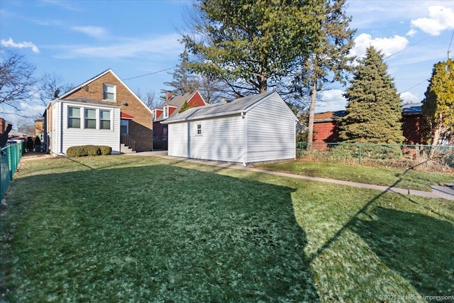 view of yard featuring fence and an outdoor structure