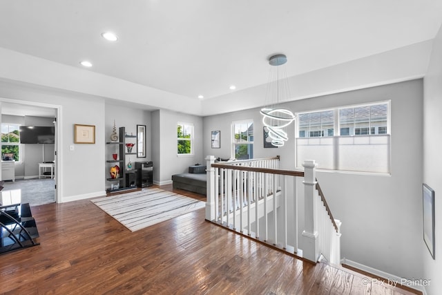 hall with recessed lighting, baseboards, an upstairs landing, and hardwood / wood-style flooring