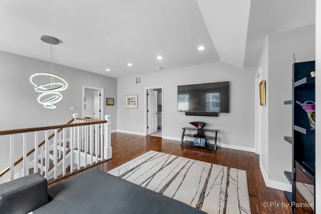 living area featuring baseboards, an inviting chandelier, wood finished floors, and recessed lighting