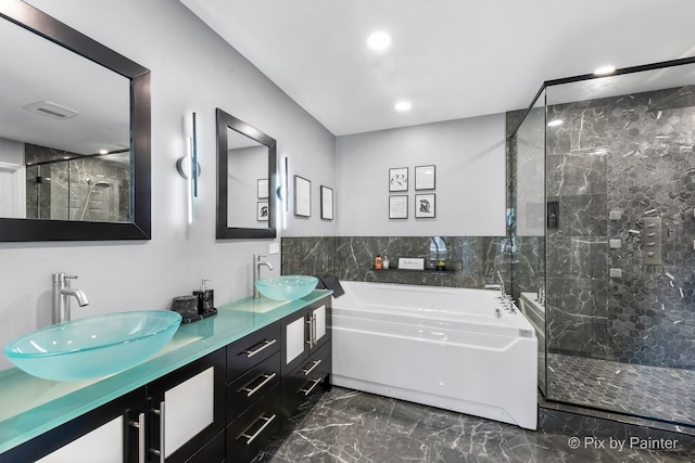 full bath with marble finish floor, a sink, a bath, and a shower stall