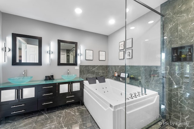 bathroom with marble finish floor, a sink, a jetted tub, and double vanity