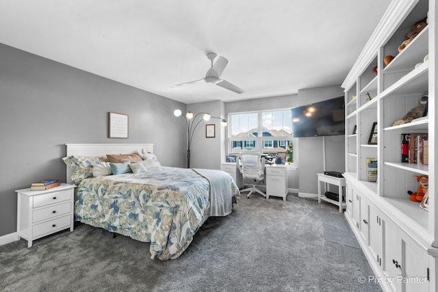 bedroom with ceiling fan, dark carpet, and baseboards