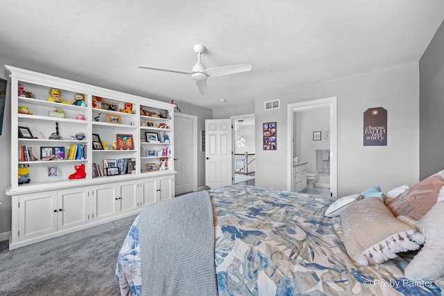 carpeted bedroom featuring ceiling fan, ensuite bath, and visible vents