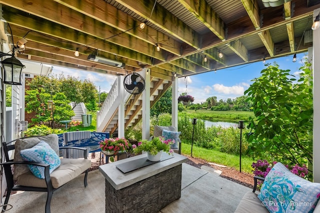 view of patio featuring stairs and a water view