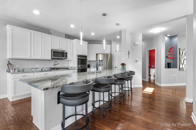 kitchen featuring stainless steel appliances, dark wood-type flooring, visible vents, and white cabinets