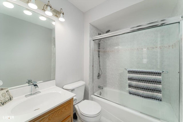 full bathroom with shower / bath combination with glass door, vanity, and toilet