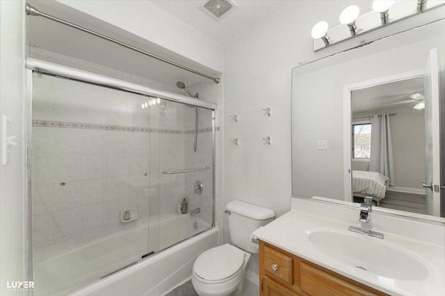 ensuite bathroom featuring toilet, shower / bath combination with glass door, vanity, visible vents, and ensuite bath