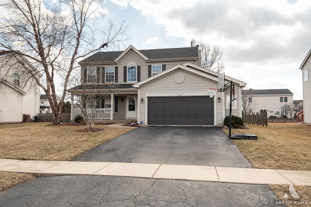 view of front of property with covered porch, a front lawn, fence, and aphalt driveway