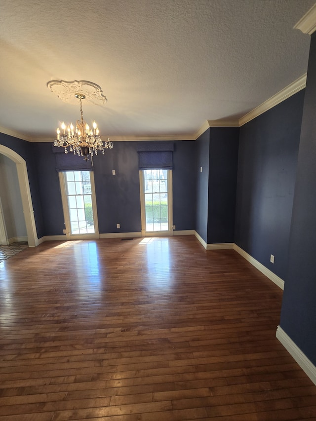 spare room with crown molding and dark wood-type flooring