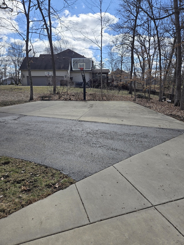 exterior space featuring concrete driveway and community basketball court