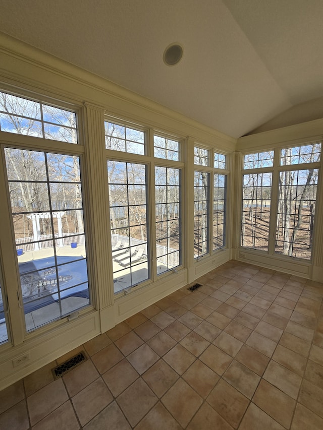 unfurnished sunroom with visible vents and vaulted ceiling