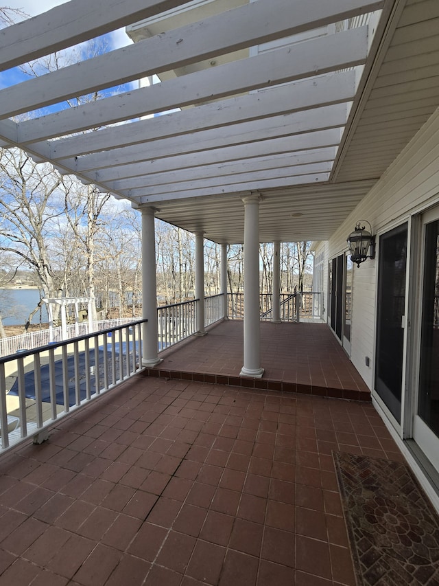 view of patio featuring a water view and a pergola