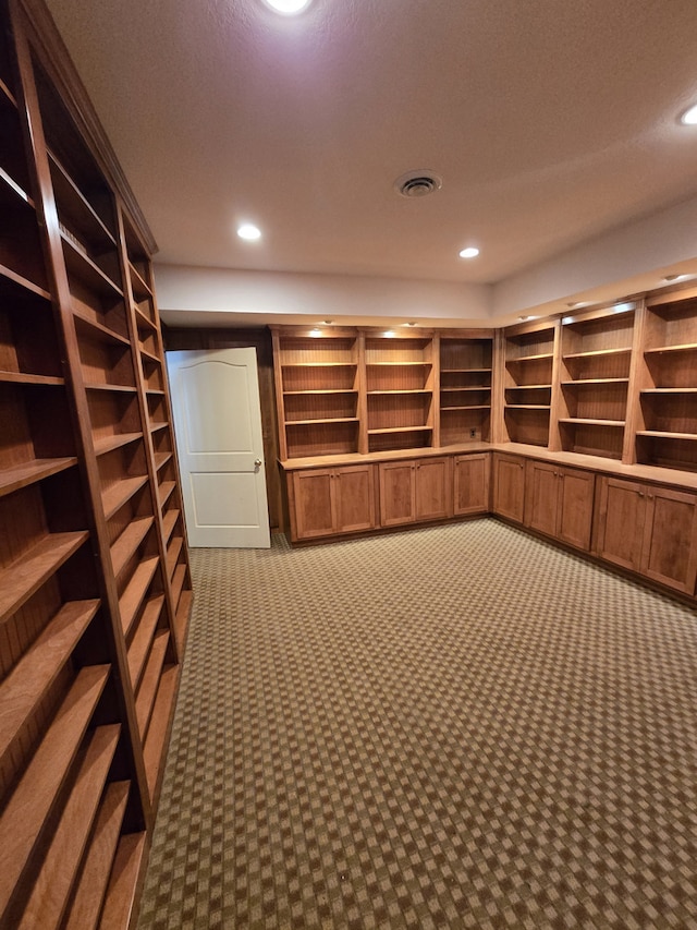 walk in closet featuring visible vents and carpet flooring