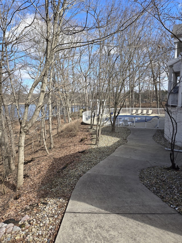 view of yard featuring fence and a pool